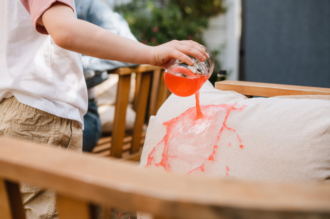Child pouring juice on protected pillow with ProofPlus