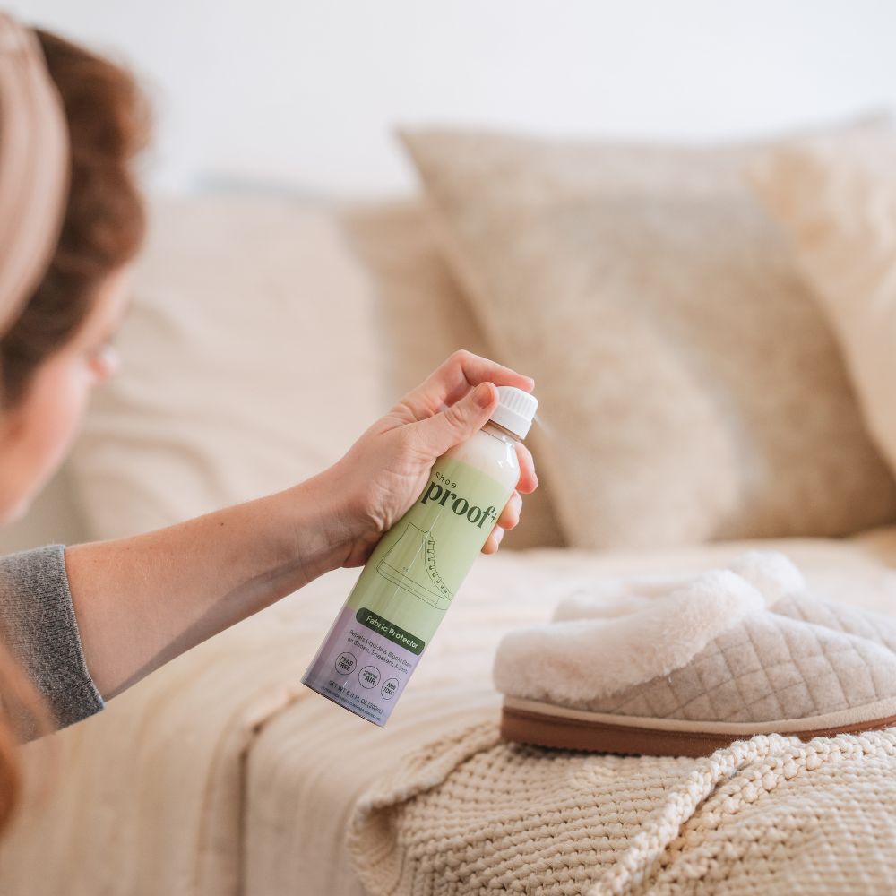 Mom spraying her slippers with ProofPlus Shoe Fabric Protector