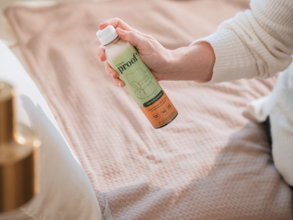 woman using ProofPlus Home Fabric Protector on her pillow case