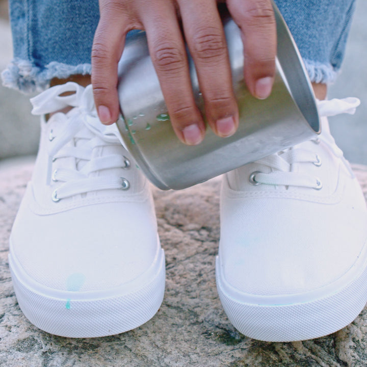 blue liquid staining unprotected white shoes compared to rolling off protected white shoes