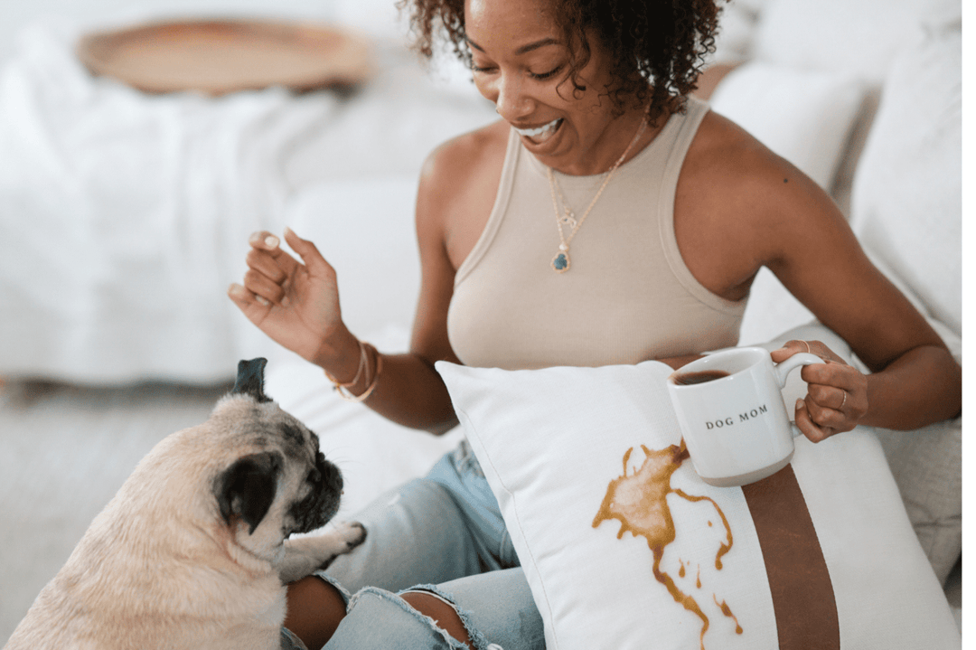 Women spilling Coffee with Dog