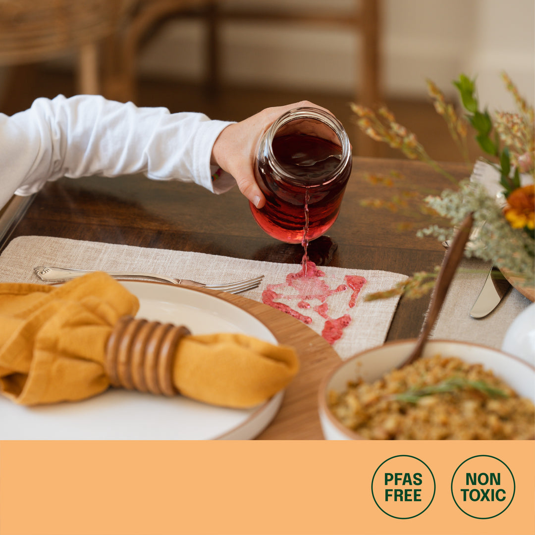 stain-free table setting after cranberry juice spill, icons of PFAS-free and non-toxic