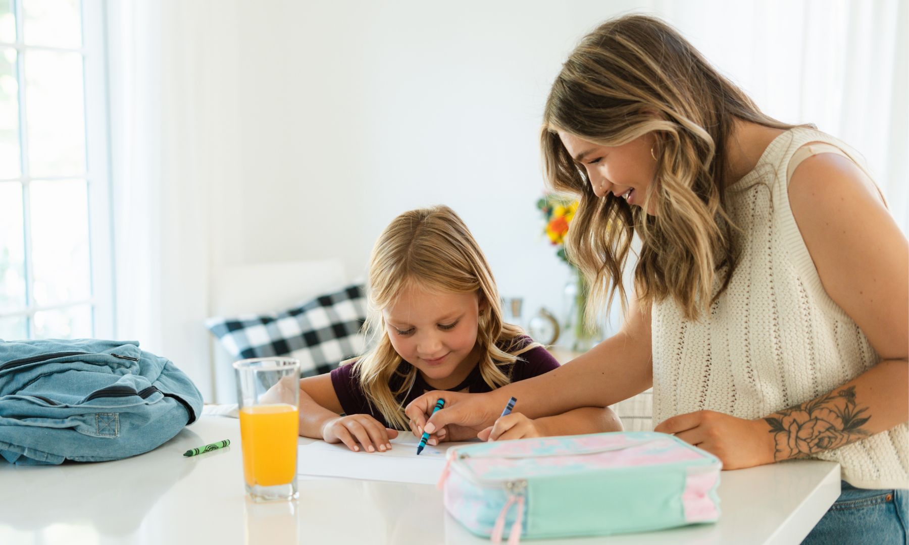 mother and daughter coloring in the morning before school