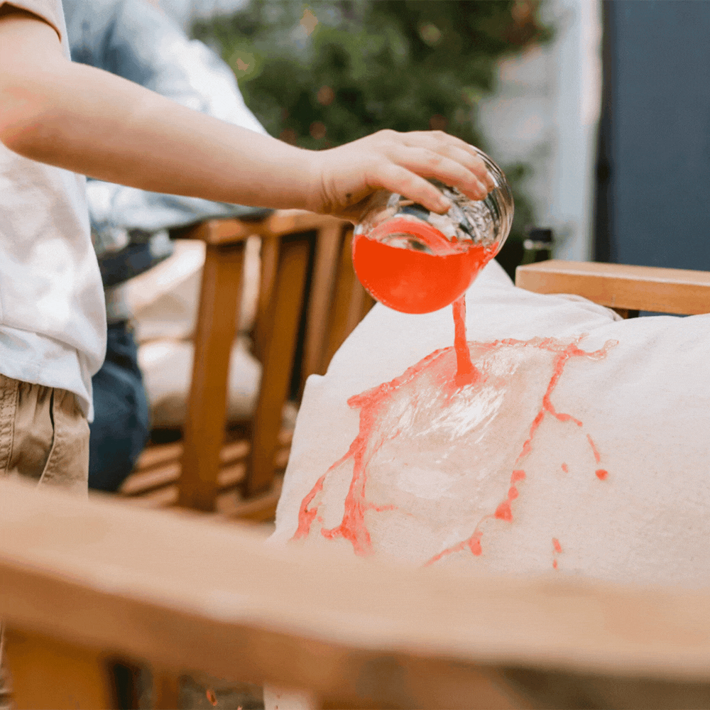 red liquid rolling off a fabric protected outdoor chair cushion